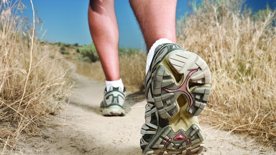 feet in athletic shoes on a walking path